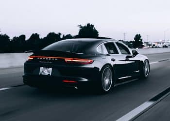 running black Porsche sedan