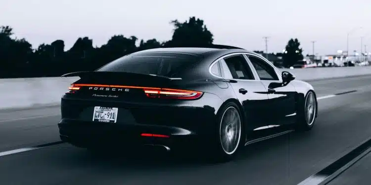 running black Porsche sedan