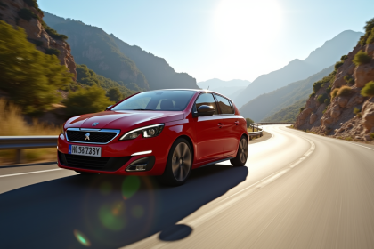 Peugeot 308 GTI rouge en pleine vitesse sur une route de montagne